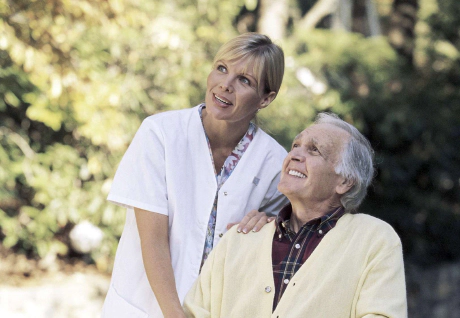 senior assis avec infirmiere regard vers l'horizon