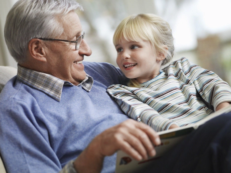 homme âgé fait la lecture à une petite fille